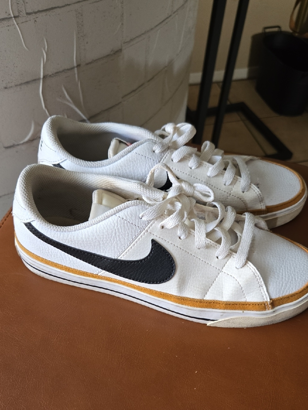 Nike White Low-Top Sneakers with Black Swoosh and Yellow Trim